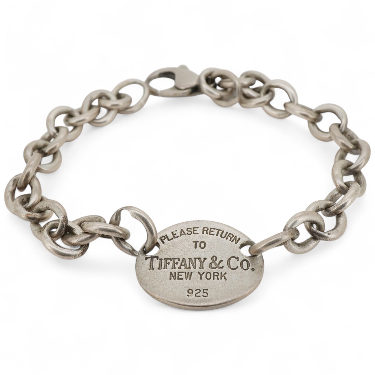 Tiffany & Co, a silver 'Return to Tiffany' bracelet, circa 2006, the oval plaque reading 'Please Return to Tiffany & Co. New York 925' on a belcher link chain, in silver, length 21.5cm, British hallmarks for silver, make